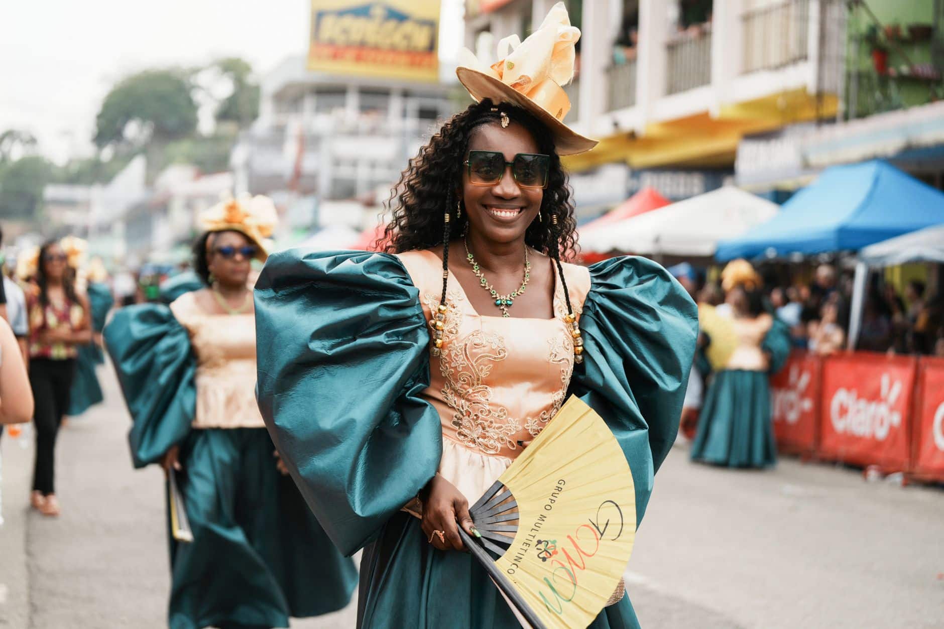 Dancers in bright costumes parading through the street during a Caribbean carnival celebration in London