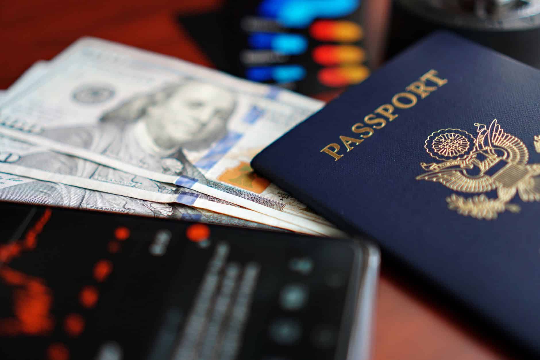 United States permanent resident green card held next to a foreign passport on a desk