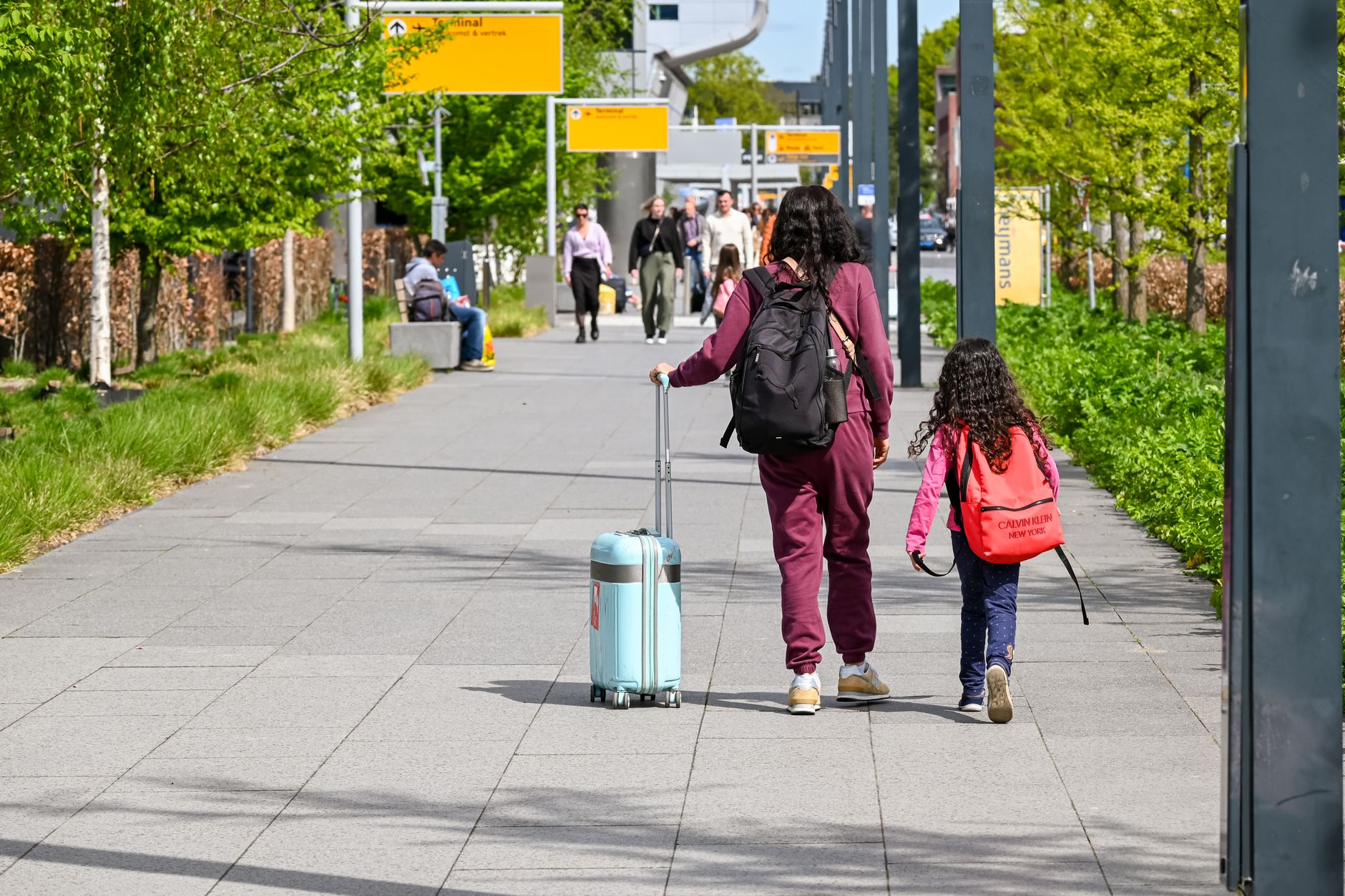 Family with a child walking through airport departures ahead of a UK visit