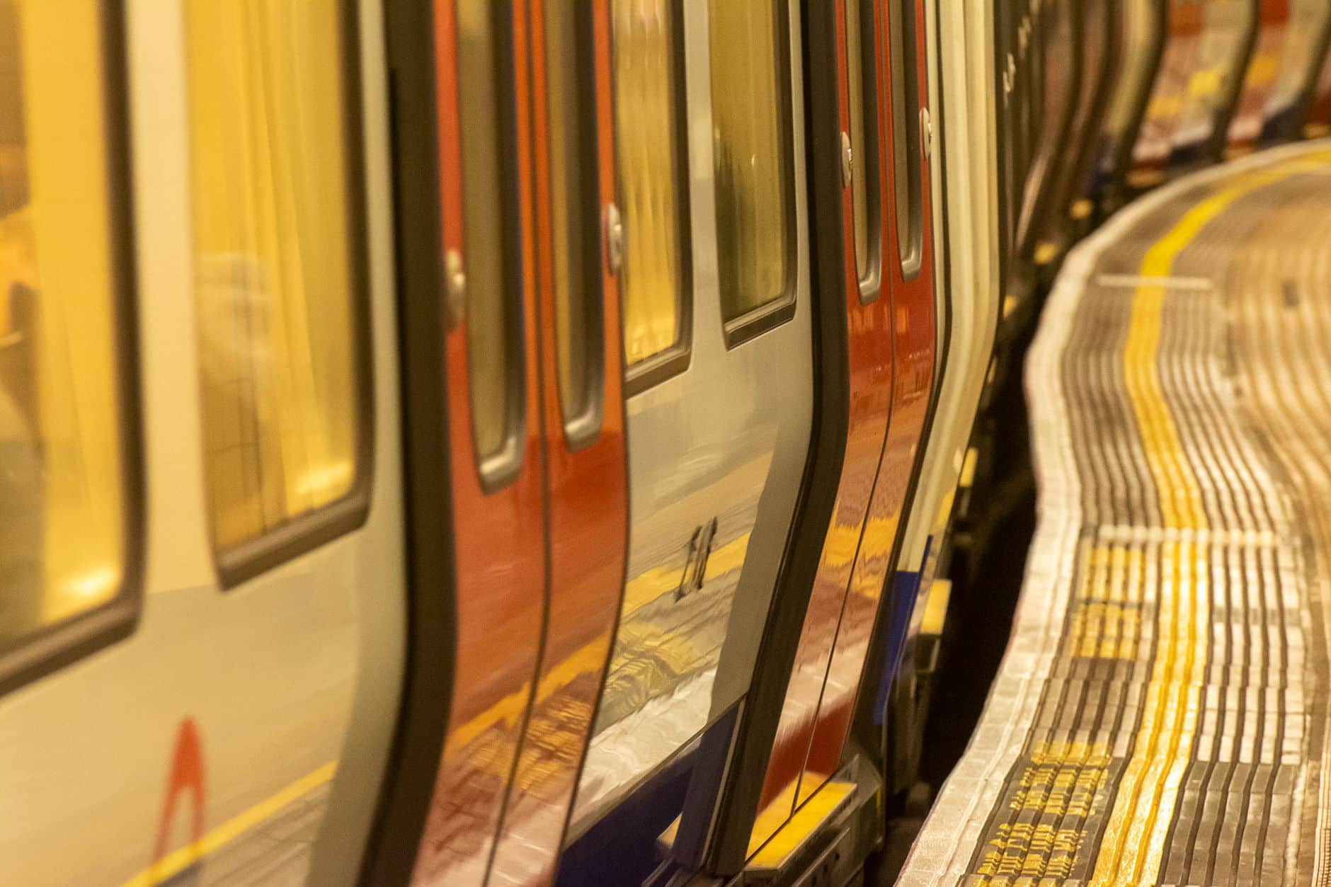 London Underground tube train arriving at a busy central London platform