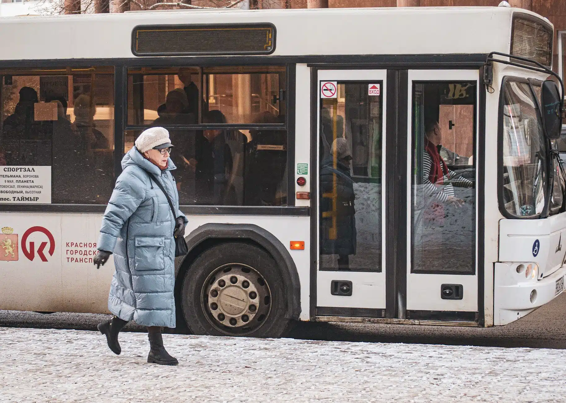 Traveller wrapped in a thermal coat on a cold UK street at New Year