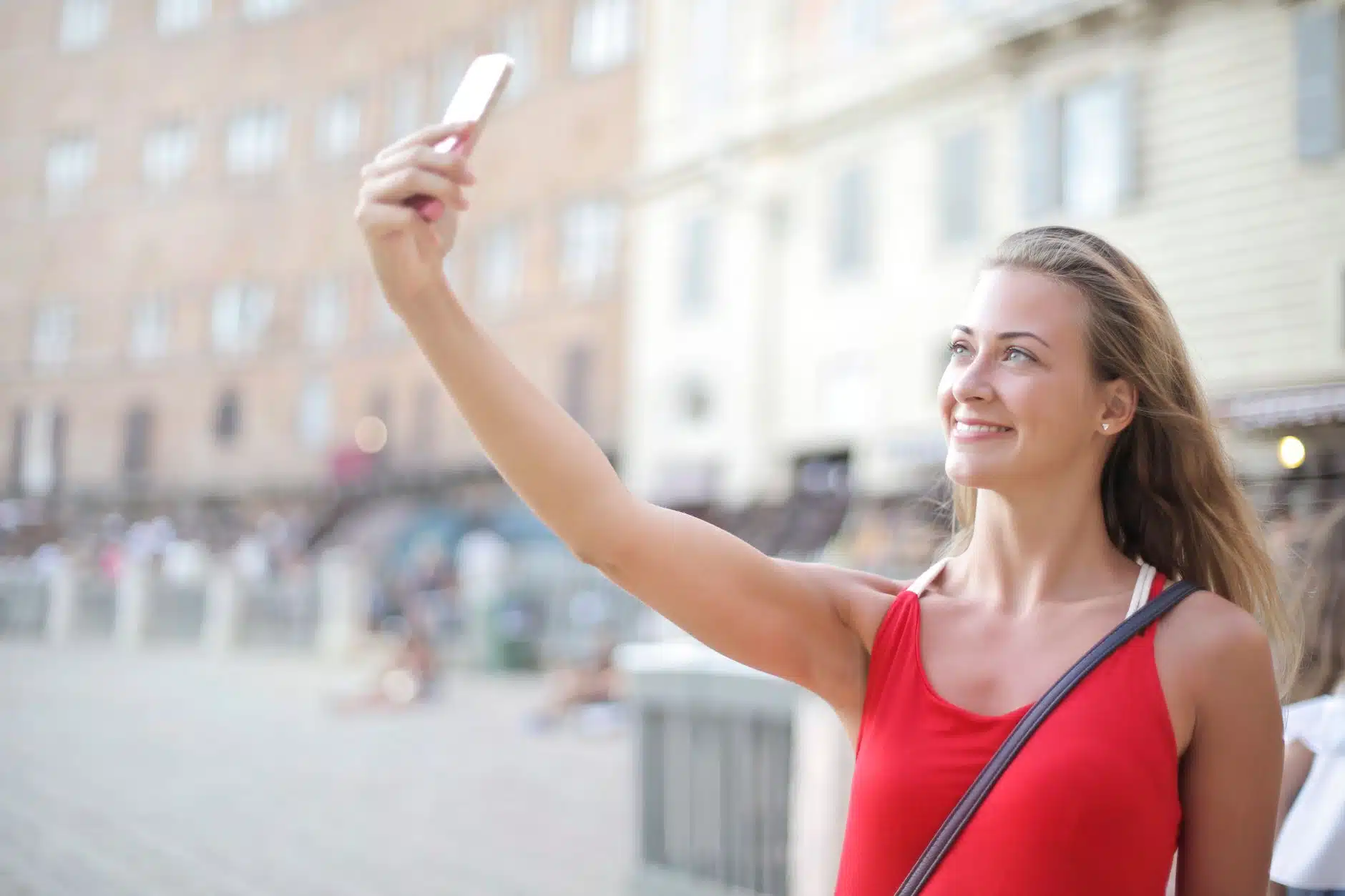 Traveller taking a facial photo on a smartphone to apply for a UK travel authorisation